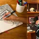 andy reid poses with sharpie pen and person draws and colors with pen